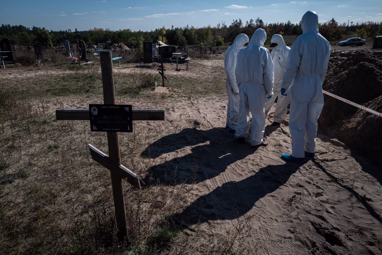 Authorities exhume the graves of civilians who were killed in Lyman, Ukraine on October 15.