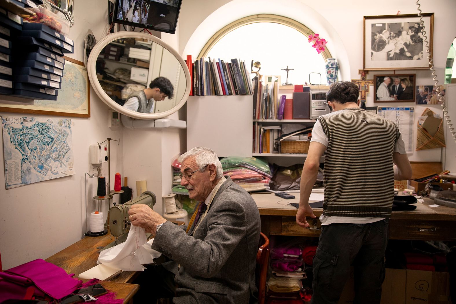 Italian tailor Raniero Mancinelli works at his shop in Rome on Wednesday, May 7. For decades, Mancinelli has personally handcrafted the white cassocks that popes wear on the day of their election.