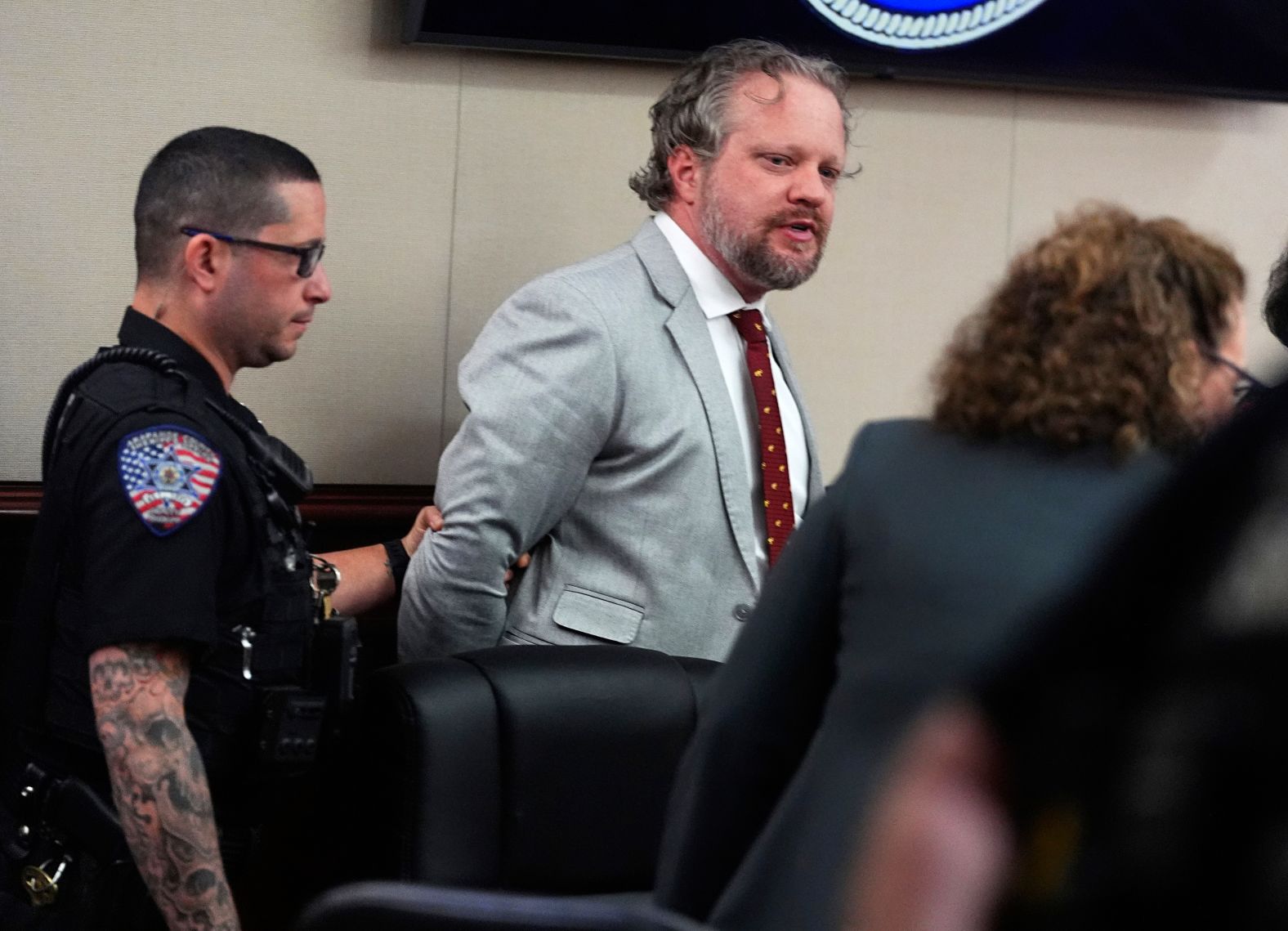 James Craig is led away on Wednesday, July 30, after a jury in Centennial, Colorado, found him guilty of killing his wife by poisoning her protein shakes. Judge Shay Whitaker <a href="index.php?page=&url=https%3A%2F%2Fwww.cnn.com%2Fus%2Flive-news%2Fjames-craig-dentist-murder-trial-07-30-25">sentenced him to life in prison</a> without the possibility of parole.