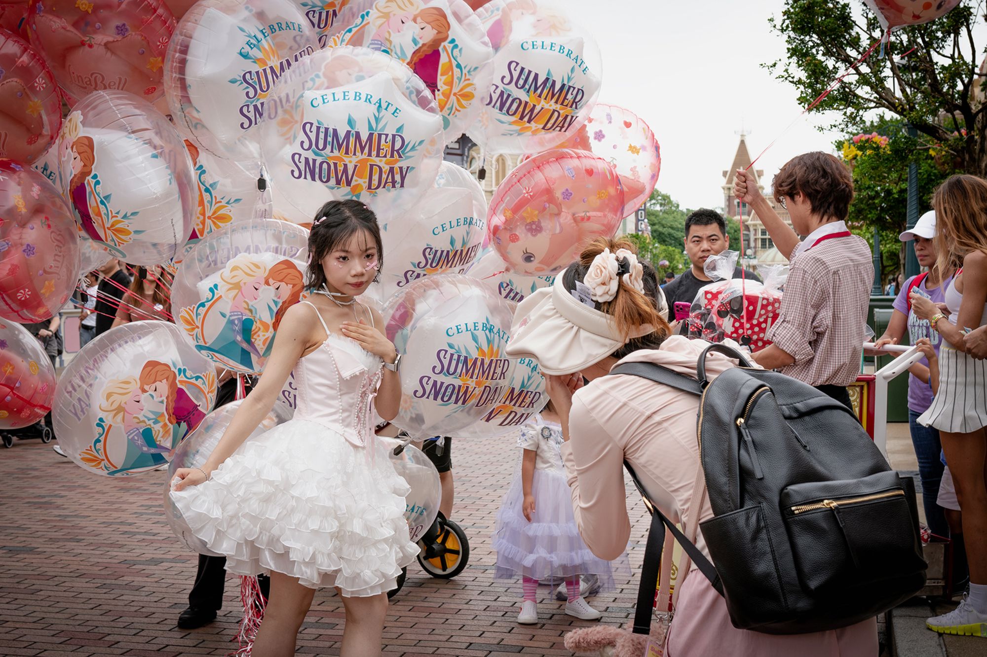 Deng Chundan, 16, and her friend take pictures inside Hong Kong Disneyland.