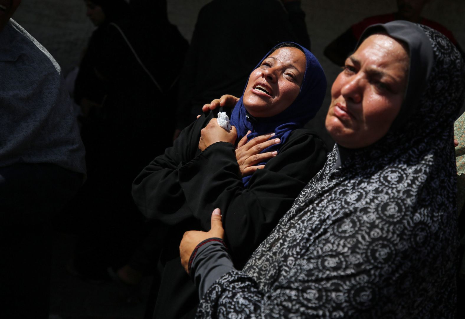 Palestinian women mourn loved ones outside a hospital in Deir al-Balah, Gaza, after an Israeli bombardment on Saturday, June 8.