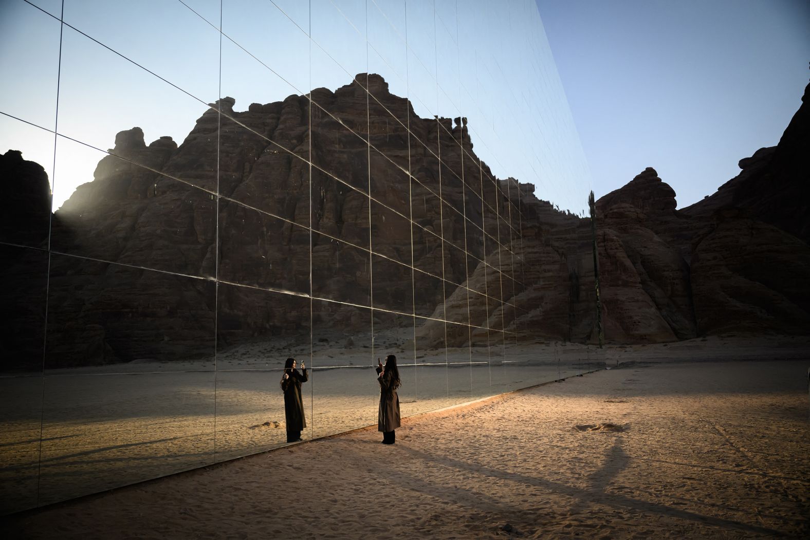 A woman takes photos outside the Maraya concert hall in AlUla, Saudi Arabia, on Monday, January 27. Maraya, <a href="index.php?page=&url=https%3A%2F%2Fwww.cnn.com%2Ftravel%2Fmaraya-alula-saudi-arabia-architecture%2Findex.html">the world’s largest mirrored building</a>, was designed by Florian Boje.