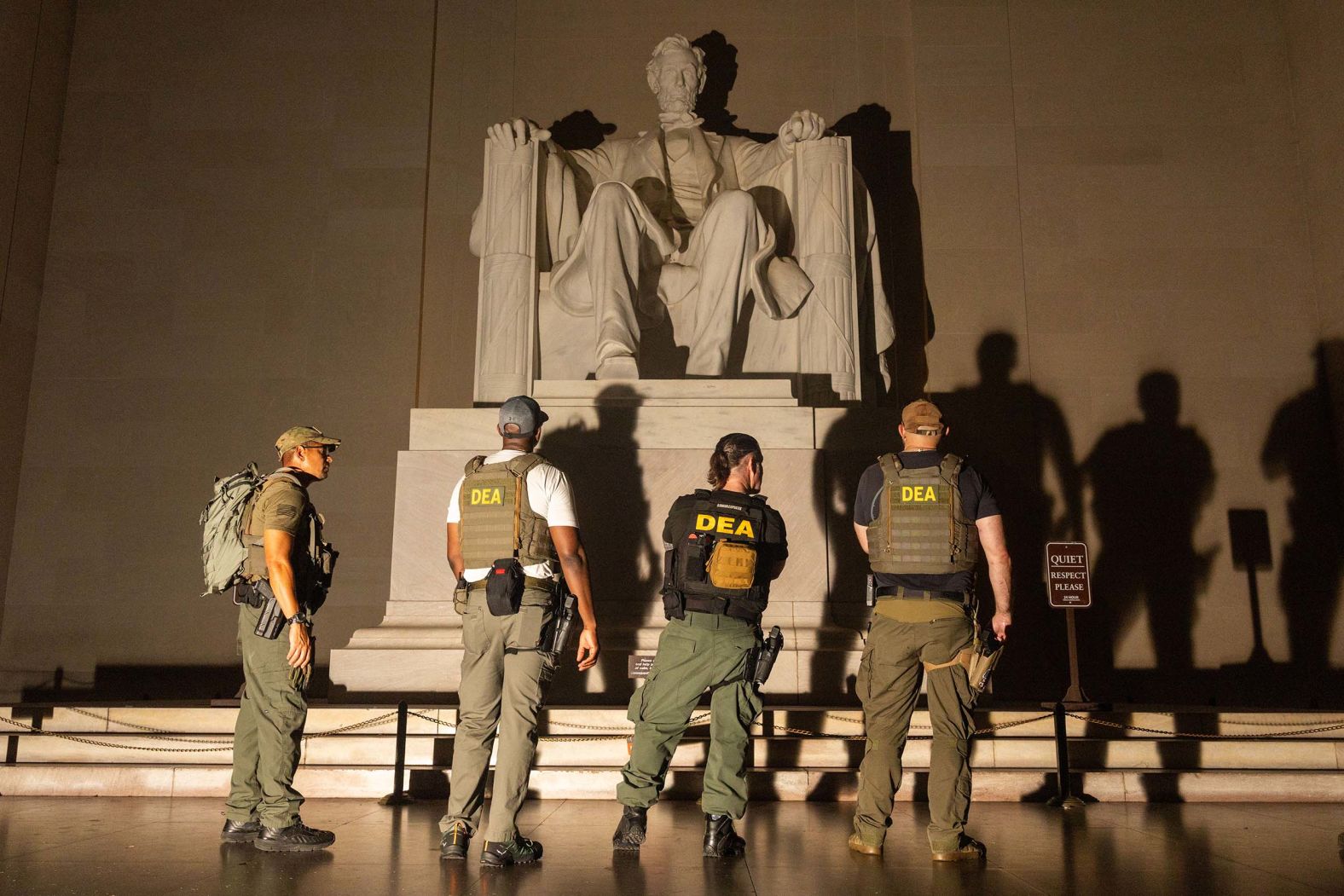 Police and members of the Drug Enforcement Agency patrol the Lincoln Memorial in Washington, DC, on Friday, August 15. President Trump has deployed members of the National Guard and agents from numerous federal agencies throughout the nation's capital.