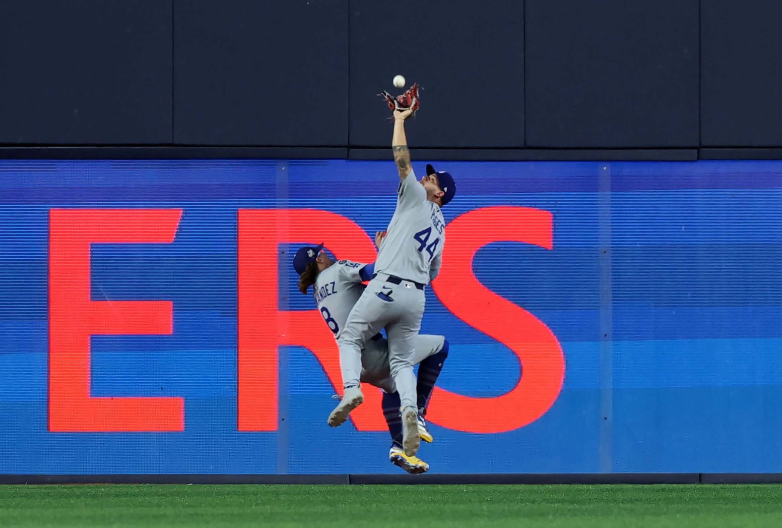 Los Angeles Dodgers center fielder Andy Pages makes a catch as he collides with teammate Enrique Hernández during <a href="index.php?page=&url=https%3A%2F%2Fwww.cnn.com%2Fsport%2Flive-news%2Fworld-series-dodgers-blue-jays-11-01-25">Game 7 of the World Series</a> on Saturday, November 1. The clutch play ended a dramatic ninth inning that also saw Dodgers second baseman Miguel Rojas hit a game-tying home run and throw out a Toronto player at the plate. The Dodgers went on to win in extra innings.