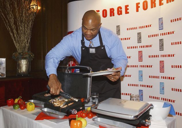 Foreman shows off one of his George Foreman grills in London in 2003. It went on to sell more than 100 million units worldwide.