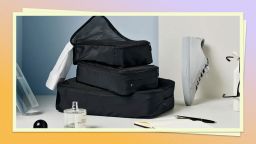 July packing cubes stock photo with other travel products in background