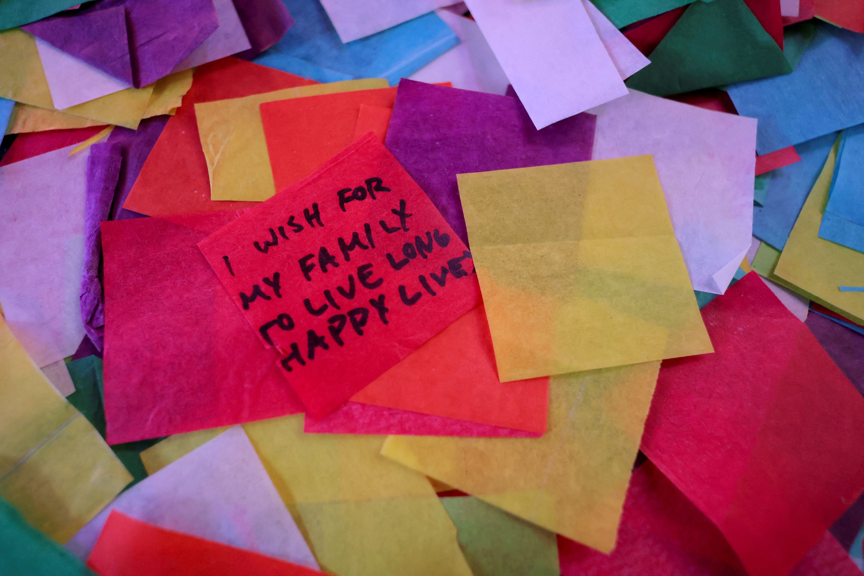 A New Year wish written on confetti lies on the ground in Times Square.