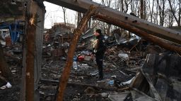 TOPSHOT - A policeman examines the damage outside an apartment building after the overnight Russian drones attack in Kharkiv, December 31, 2023, amid the Russian invasion of Ukraine. Kyiv said on December 31, 2023, it destroyed 21 of 49 Iranian-made "Shahed" drones fired by Russia overnight, adding that six guided missiles had also targeted the northeastern city of Kharkiv. (Photo by SERGEY BOBOK / AFP) (Photo by SERGEY BOBOK/AFP via Getty Images)