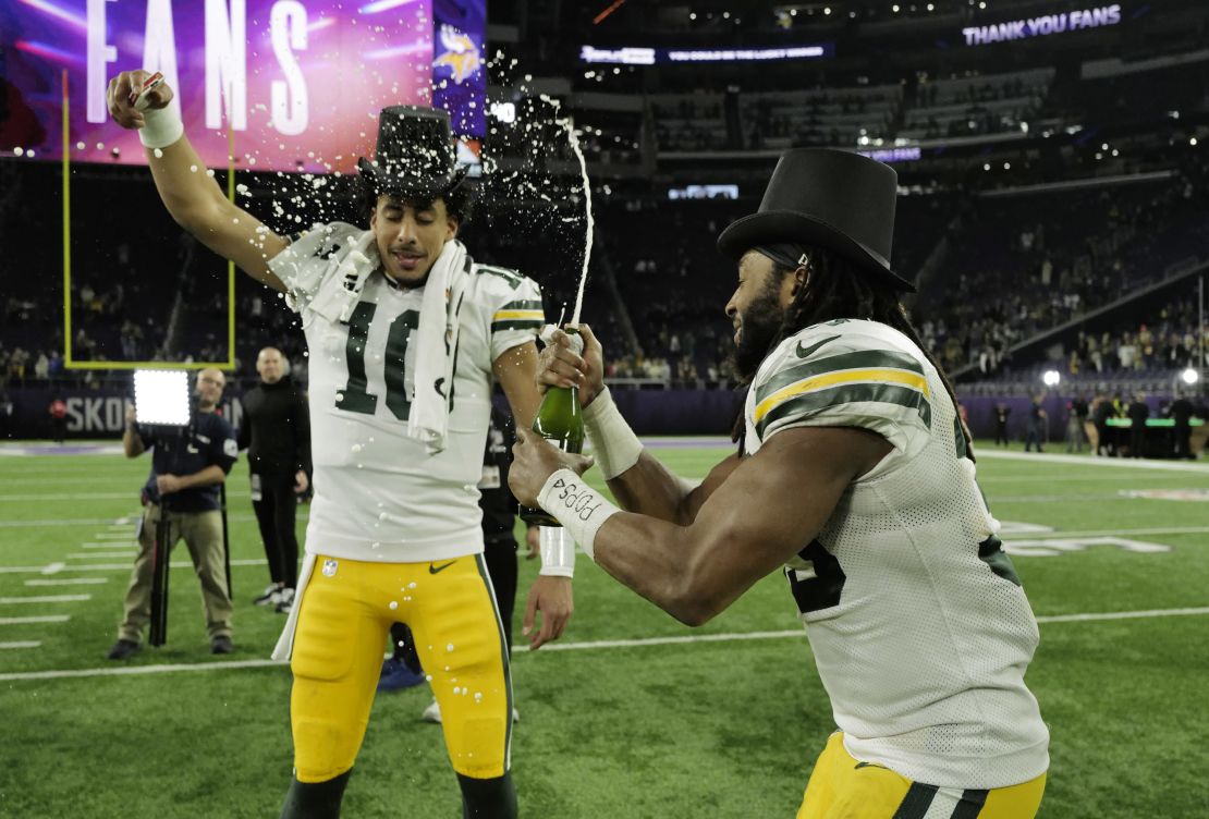 MINNEAPOLIS, MINNESOTA - DECEMBER 31: Jordan Love #10 and Aaron Jones #33 of the Green Bay Packers celebrate after a 33-10 victory against the Minnesota Vikings at U.S. Bank Stadium on December 31, 2023 in Minneapolis, Minnesota. (Photo by Stephen Maturen/Getty Images)