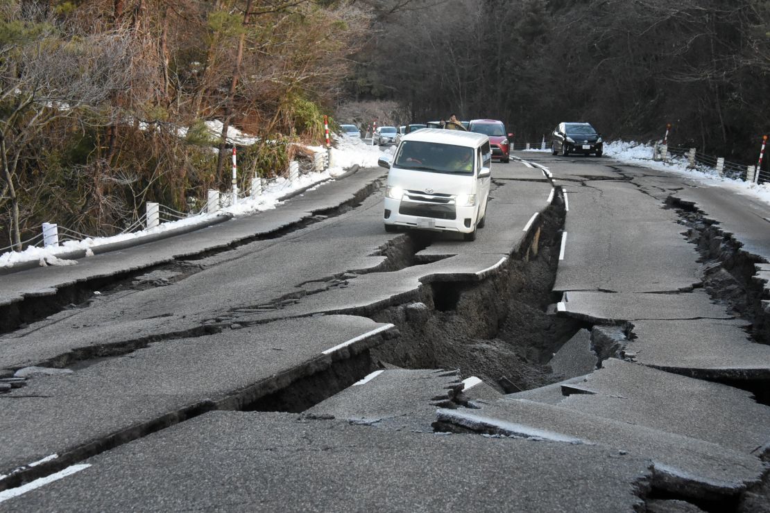 NOTO, JAPAN - JANUARY 02: (EDITORS' NOTE: A part of this image has been pixeled) Cars are stranded in the cracks as the road has been damaged by multiple strong earthquakes on January 2, 2024 in Noto, Ishikawa, Japan. A tsunami warning was issued Japan's coastline after a series of earthquakes, the biggest measuring 7.1 magnitude, hit the areas around Toyama and Niigata in central Japan. At least 7 people confirmed dead in Ishikawa Prefecture, where is the epicenter of the earthquakes. (Photo by The Asahi Shimbun via Getty Images)