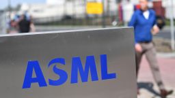 An employee walks past an ASML logo, a Dutch company which is currently the largest supplier in the world of semiconductor manufacturing machines via photolithography systems in Veldhoven on April 17, 2018. - They call it "the shrink" -- it's the challenge of how to pack more information onto the microchips which power everything from our phones to our computers, even our coffee machines. And pushing today's boundaries of science and technology is the Dutch company ASML, which since its foundation in 1984 has quietly become a world leader in the semiconductor business. (Photo by EMMANUEL DUNAND / AFP)        (Photo credit should read EMMANUEL DUNAND/AFP via Getty Images)
