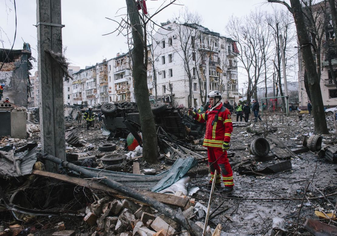 A firefighter responds to a rocket blast at a residential building in the eastern Ukrainian region of Kharkiv, January 2, 2023.