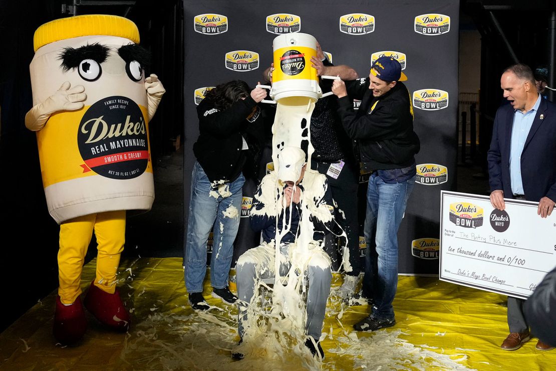 Dec 27, 2023; Charlotte, NC, USA; West Virginia Mountaineers head coach Neal Brown gets covered in mayonnaise after the game at Bank of America Stadium. Mandatory Credit: Bob Donnan-USA TODAY Sports