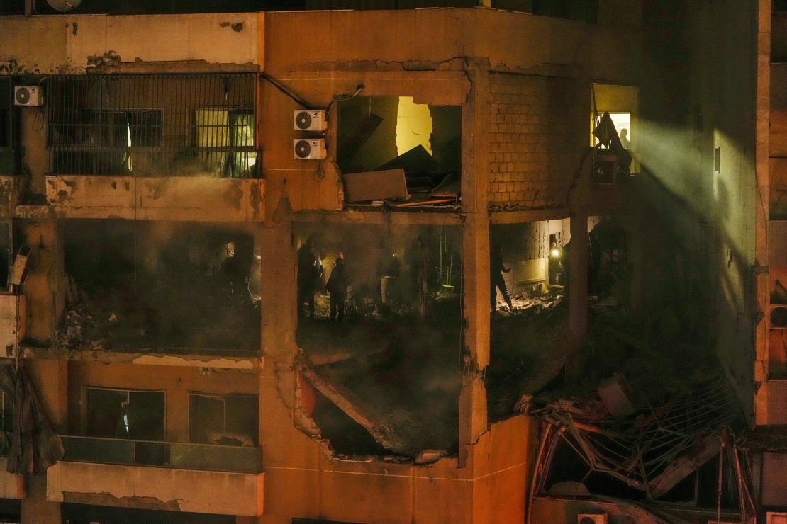 People search for survivors inside an apartment following a massive explosion in the southern suburb of Beirut, Lebanon, Tuesday, Jan. 2, 2024.