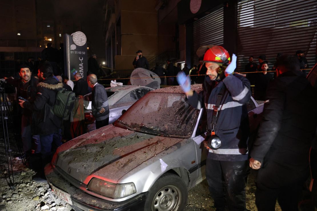 Lebanese emergency responders gather at the site of a strike, reported by Lebanese media to be an Israeli strike targeting a Hamas office, in the southern suburb of Beirut on January 2, 2024.