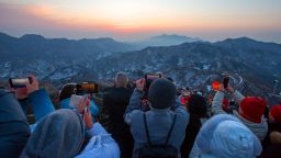 Tourists step on the Great Wall to watch sunrise on New Year's Day on January 1, 2024 in Beijing, China.