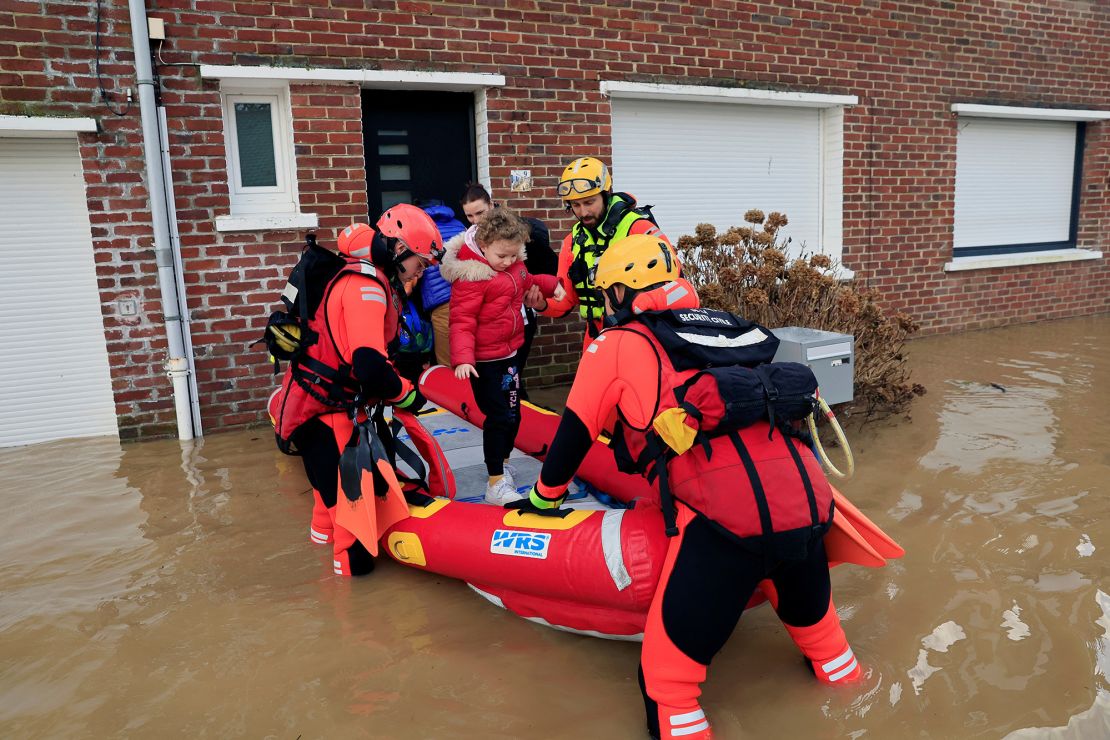 Members of French Civil Security rescue team evacuate local residents by boat as the Aa River overflows in Arques near Saint-Omer, after heavy rain caused flooding in northern France, January 3, 2024. REUTERS/Pascal Rossignol