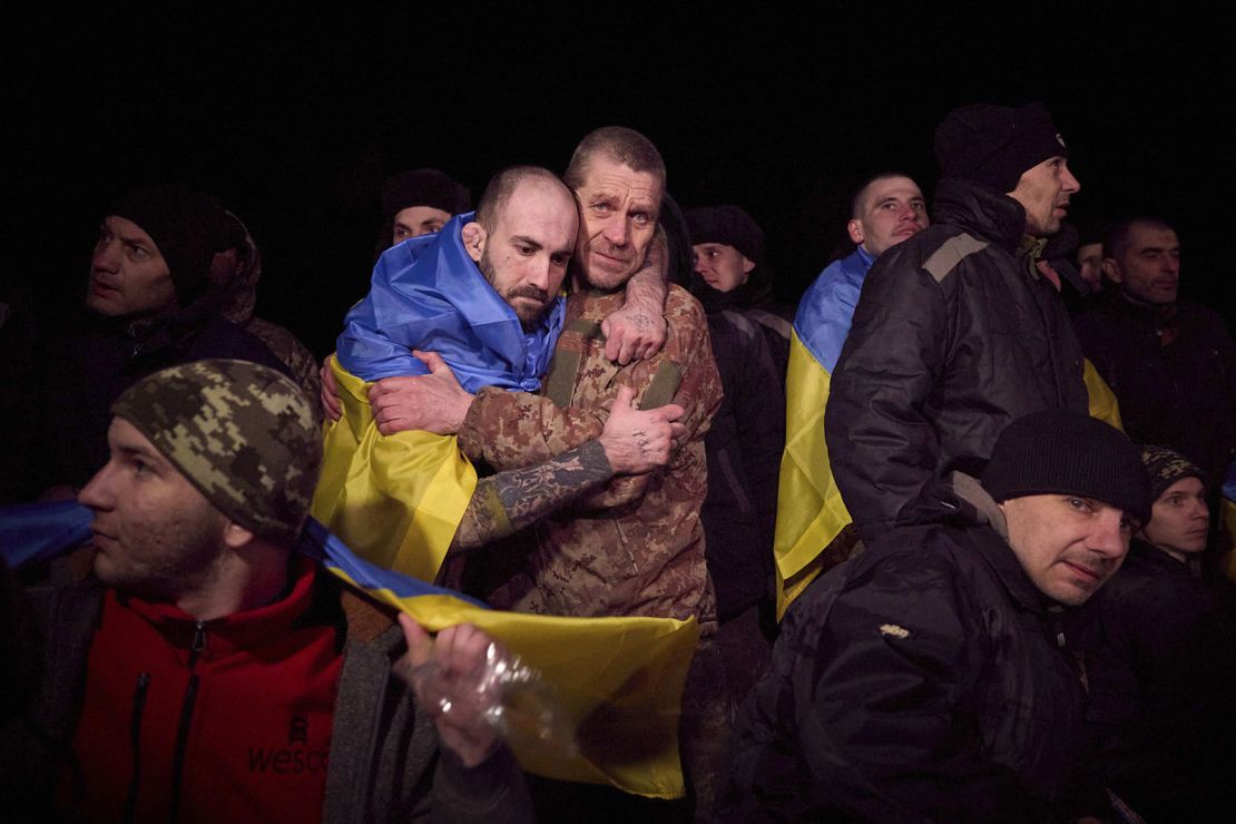 In this photo provided by the Ukrainian Presidential Press Office, Ukrainian prisoners of war react after prisoner exchange near Sumy, Ukraine, Wednesday, Jan. 3, 2024. Russia and Ukraine on Wednesday exchanged hundreds of prisoners of war in the biggest single release of captives since Russia's full-scale invasion in February 2022. (Ukrainian Presidential Press Office via AP)