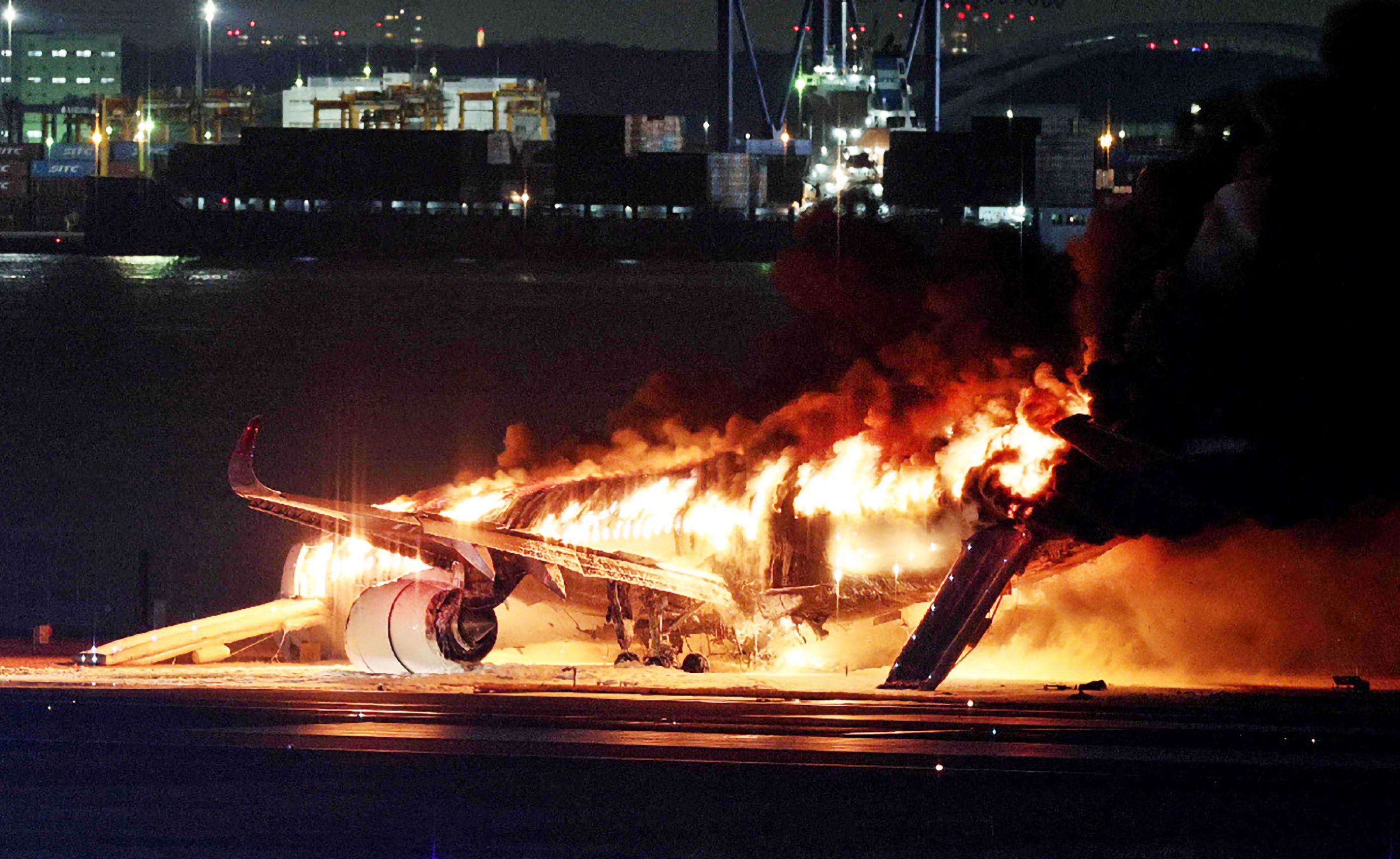 A Japan Airlines passenger plane is engulfed in flames after colliding with another aircraft on the runway of Tokyo's Haneda airport on Tuesday, January 2.
