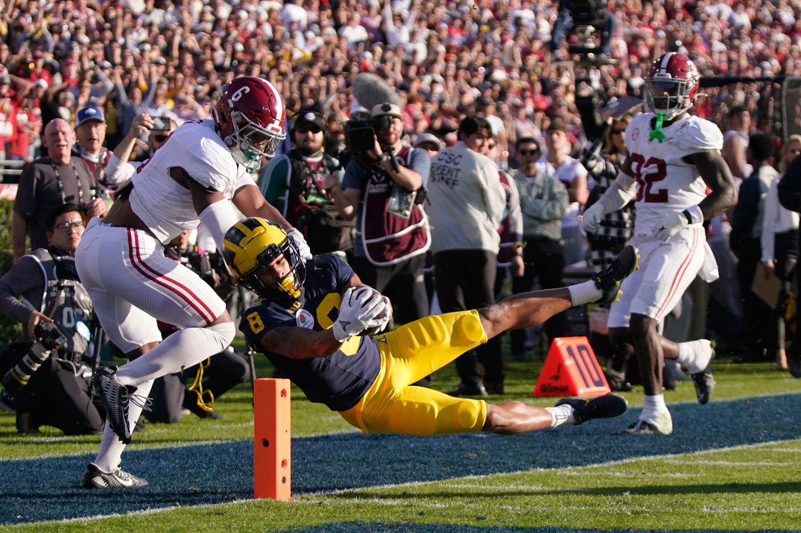 Michigan wide receiver Tyler Morris, center, scores a touchdown against Alabama during the Rose Bowl on Monday, January 1. It was one of the semifinals of the College Football Playoff, and <a href="index.php?page=&url=https%3A%2F%2Fwww.cnn.com%2F2024%2F01%2F01%2Fsport%2Fcollege-football-playoff-how-to-watch-spt-intl%2Findex.html" target="_blank">Michigan won in overtime 27-20</a>. The Wolverines will face Washington in the championship game.