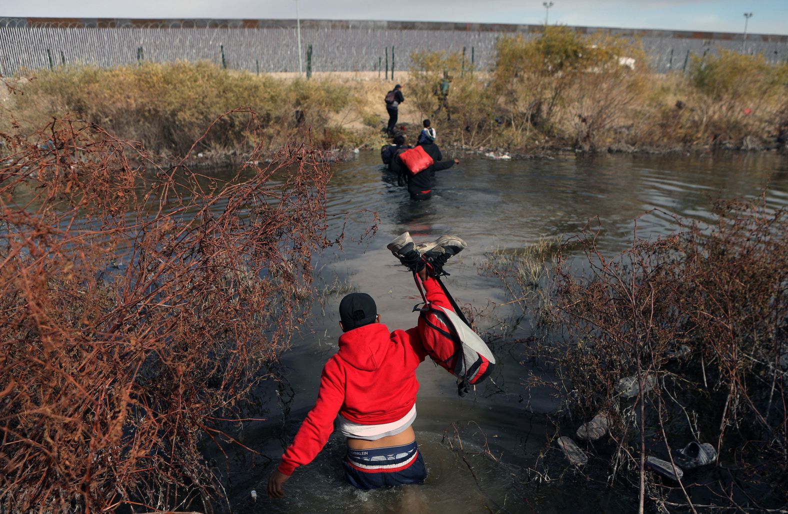 Migrants cross the Rio Grande to enter the United States from Mexico on Tuesday, January 2. <a href="index.php?page=&url=https%3A%2F%2Fwww.cnn.com%2F2023%2F12%2F29%2Fus%2Fus-mexico-border-migration%2Findex.html" target="_blank">A new surge of migrants</a> at the US-Mexico border is overwhelming already-stretched resources and prompting urgent talks with Mexican officials.