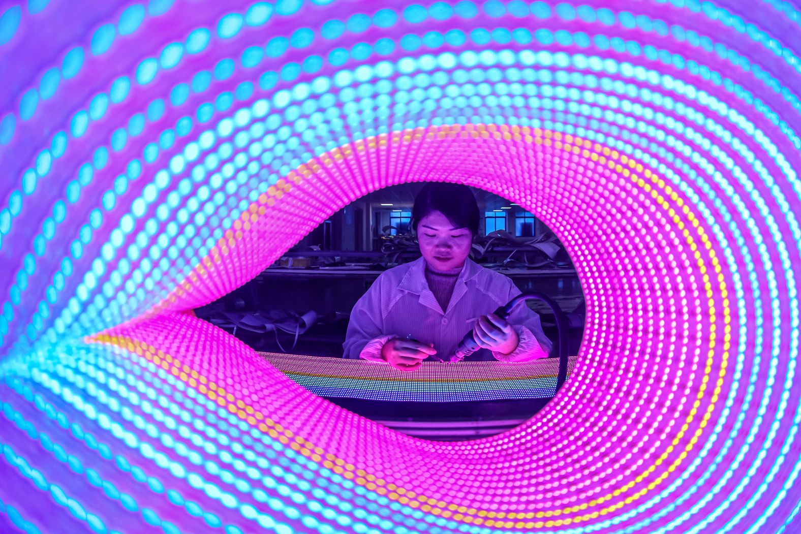 A worker checks LED lights at a factory in Ruichang, China, on Wednesday, January 3.