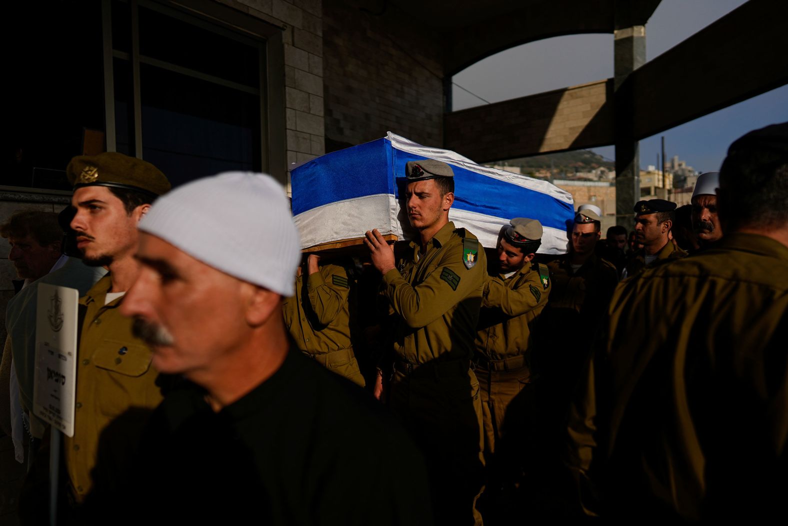 Israeli soldiers carry the flag-draped casket of Staff Sgt. Sufian Dagash during his funeral in Maghar, Israel, on Wednesday, January 3. Dagash, 21, was killed during Israel's ground operation in Gaza, where the Israeli army has been battling Hamas militants.