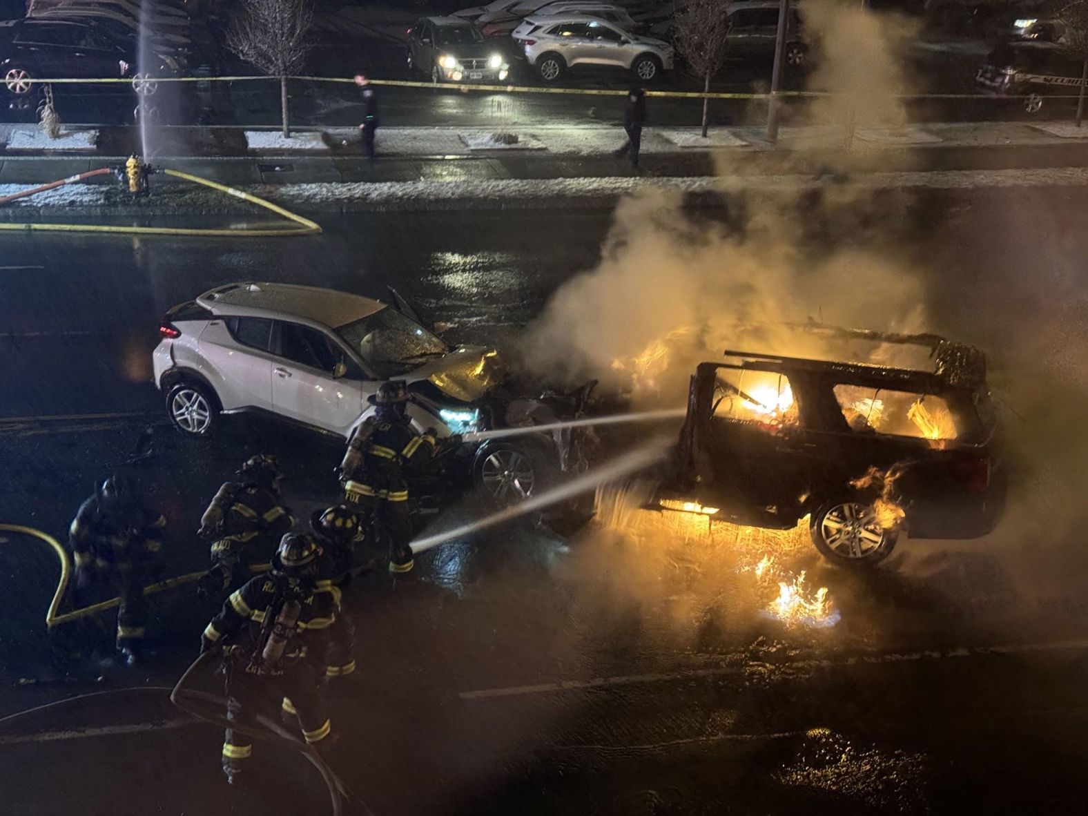 Firefighters try to extinguish a fire after a <a href="index.php?page=&url=https%3A%2F%2Fwww.cnn.com%2F2024%2F01%2F03%2Fus%2Frochester-new-york-crash-suspect-motive-wednesday%2Findex.html" target="_blank">deadly crash</a> outside a Rochester, New York, concert venue on Monday, January 1. Police say the suspect, driving an SUV full of gas canisters, appeared to "intentionally" speed toward pedestrians before slamming into another vehicle, killing two passengers and injuring several others. The suspect died after the fiery crash.