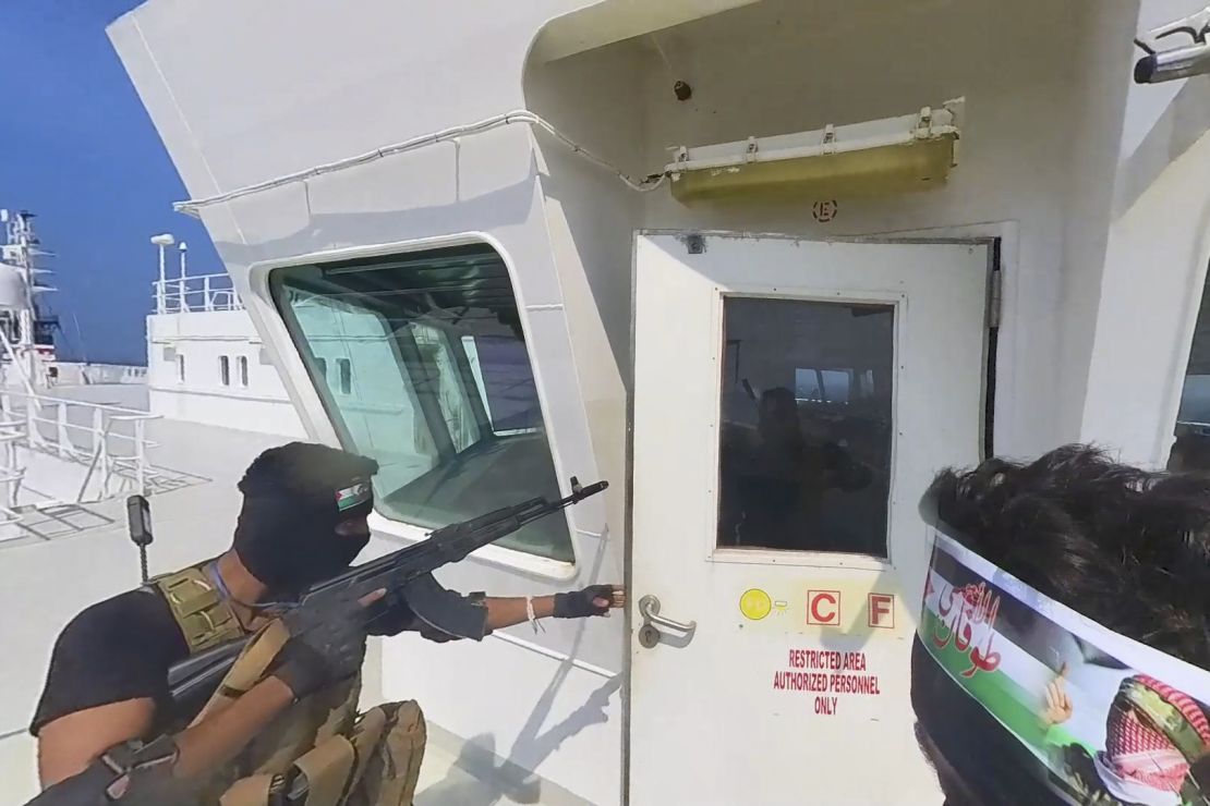 This photo released by the Houthi Media Center shows Houthi forces boarding the cargo ship Galaxy Leader on Sunday, Nov. 19, 2023. Yemen's Houthis have seized the ship in the Red Sea off the coast of Yemen after threatening to seize all vessels owned by Israeli companies. (Houthi Media Center via AP)