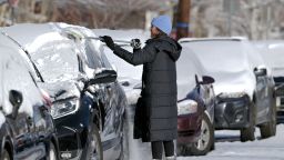 DENVER, CO - DECEMBER 9 : Keli Ramirez of Denver removes snow from her car at Grant street in Denver, Colorado on Saturday, December 9, 2023. (Photo by Hyoung Chang/The Denver Post)