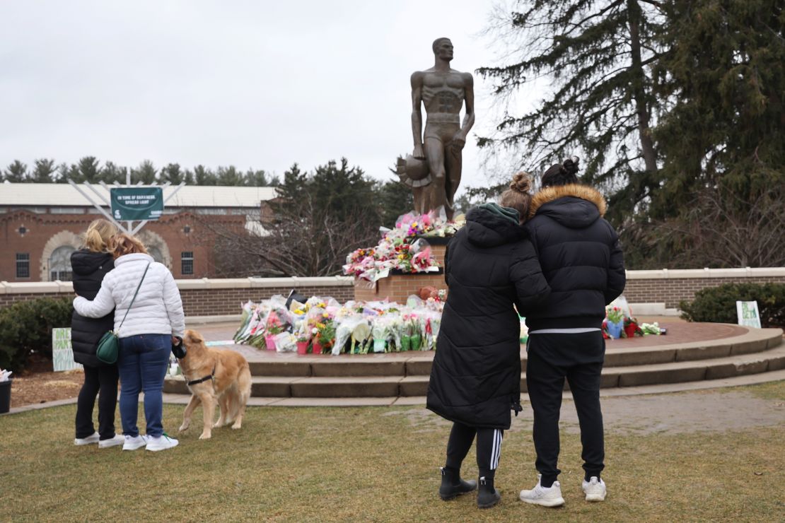 EAST LANSING, MICHIGAN - FEBRUARY 16: Flowers are laid at the base of the spartan statue on the campus of Michigan State University as a tribute to the students killed and wounded in Monday's shooting on February 16, 2023 in East Lansing, Michigan. On February 13, a gunman opened fire on the campus, killing three students and critically wounding five others. The gunman shot himself a short time later during a confrontation with law enforcement officials.   (Photo by Scott Olson/Getty Images)