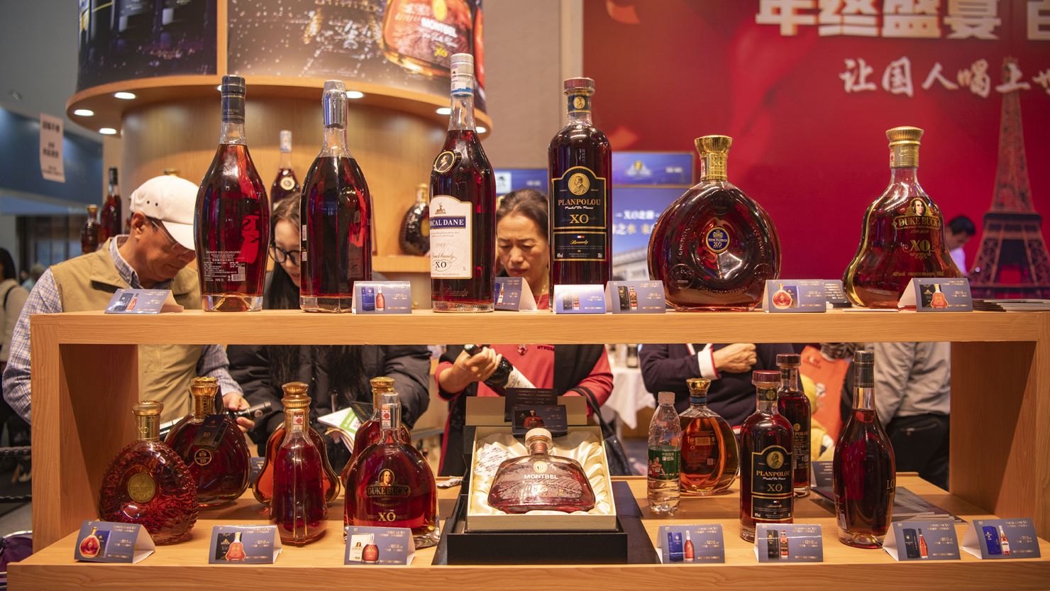 HAIKOU, CHINA - DECEMBER 17: People purchase brandies during the 26th China (Hainan) International Winter Trade Fair for Tropical Agricultural Products at Hainan International Convention And Exhibition Center on December 17, 2023 in Haikou, Hainan Province of China. (Photo by Meng Zhongde/VCG via Getty Images)