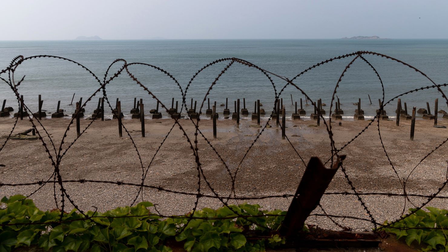 Metal spikes, known as "Dragon's teeth," and razor wire used for fortification sit along a beach as islands belonging to North Korea stand in the distance on Yeonpyeong Island, South Korea, on Friday, June 26, 2020. On the sleepy island of Yeonpyeong, the threat of conflict is constant with North Korean coastal howitzers just 11 kilometers (7 miles) away and propaganda banners visible through binoculars. There have been several military clashes in the contested maritime boundary off the west of the peninsula since 1999, making it a possible ignition point for a major conflict that could draw in the U.S. and China  the two biggest allies for the rival Koreas.