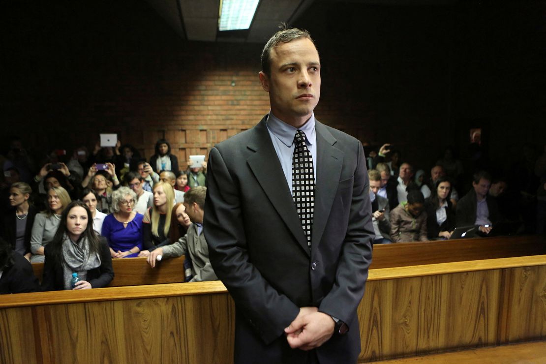 FILE PHOTO: Oscar Pistorius enters the dock before court proceedings at the Pretoria Magistrates court June 4, 2013. "Blade Runner" Pistorius arrived at court on Tuesday in his first formal appearance since his release on bail in February for the Valentine's Day killing of his girlfriend, 30-year-old model Reeva Steenkamp.