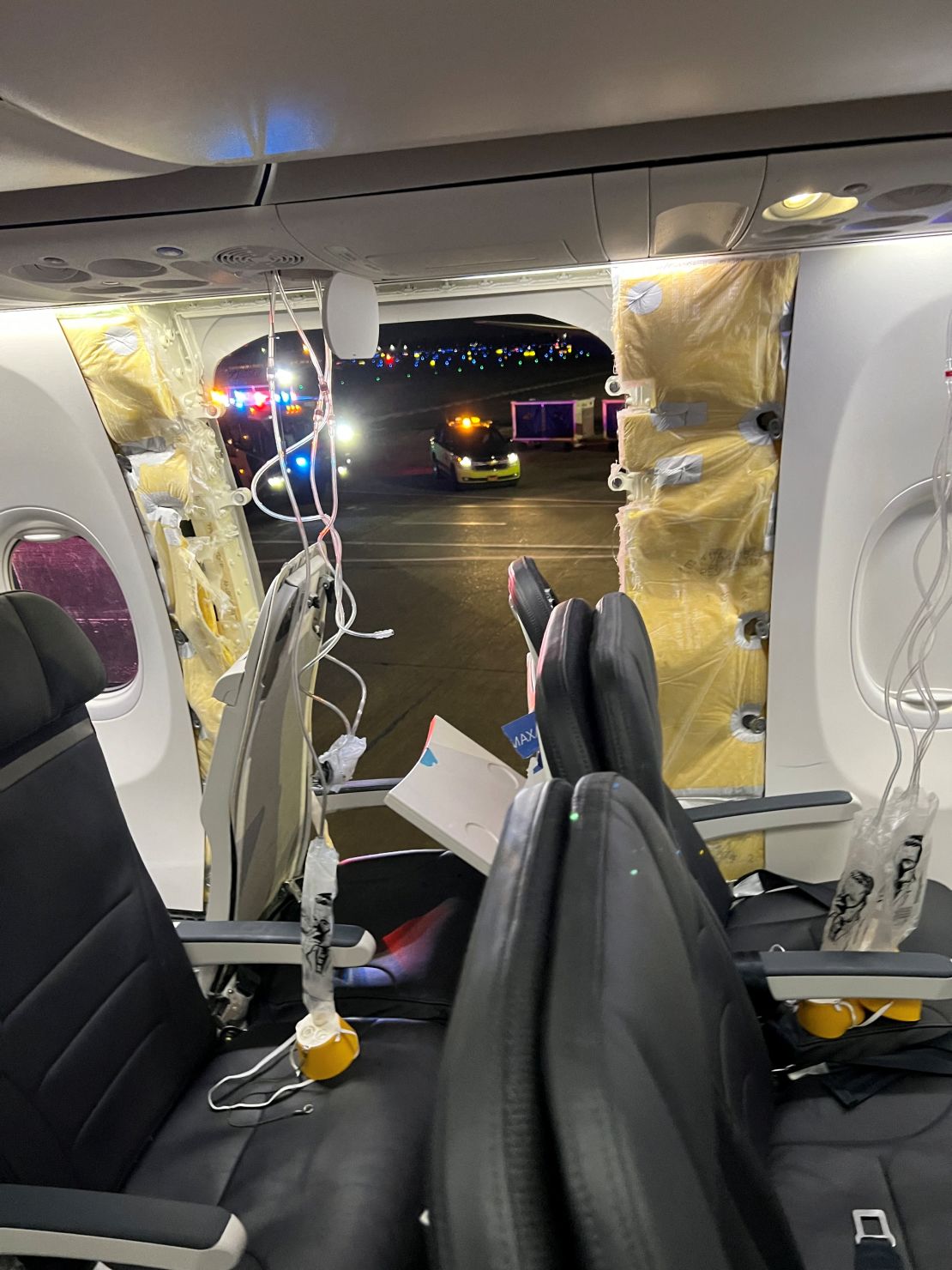 Passenger oxygen masks hang from the ceiling next to a missing window and part of the sidewall of Alaska Airlines Flight 1282, which was headed to Ontario, California and suffered decompression shortly after departure, in Portland, Oregon, US, January 5, 2024 in This photo obtained from social media.