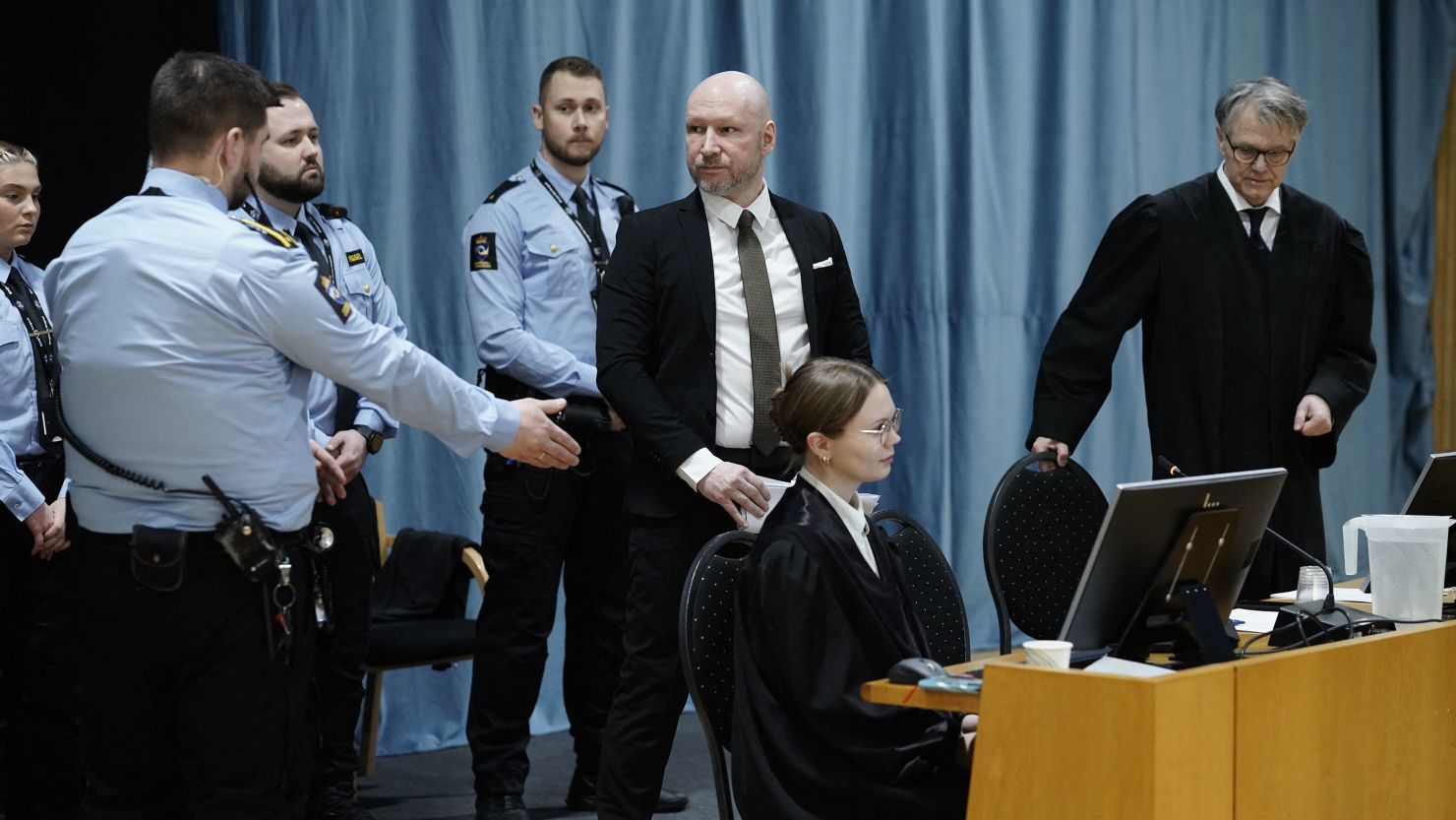 Anders Behring Breivik (3rd R) enters a courtroom at Ringerike prison before the start of his trial over his prison conditions, on January 8, 2024 in Tyristrand, Norway. Breivik, who killed 77 people in a bombing and shooting rampage in 2011 and who has been held apart from other inmates for 12 years, has sued the state for a second time arguing that his isolation is a violation of the European Convention on Human Rights. (Photo by Cornelius Poppe/NTB/AFP) / Norway OUT (Photo by CORNELIUS POPPE/NTB/AFP via Getty Images)