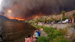 Residents watch the McDougall Creek wildfire in West Kelowna, British Columbia, Canada, on August 17, 2023, from Kelowna.