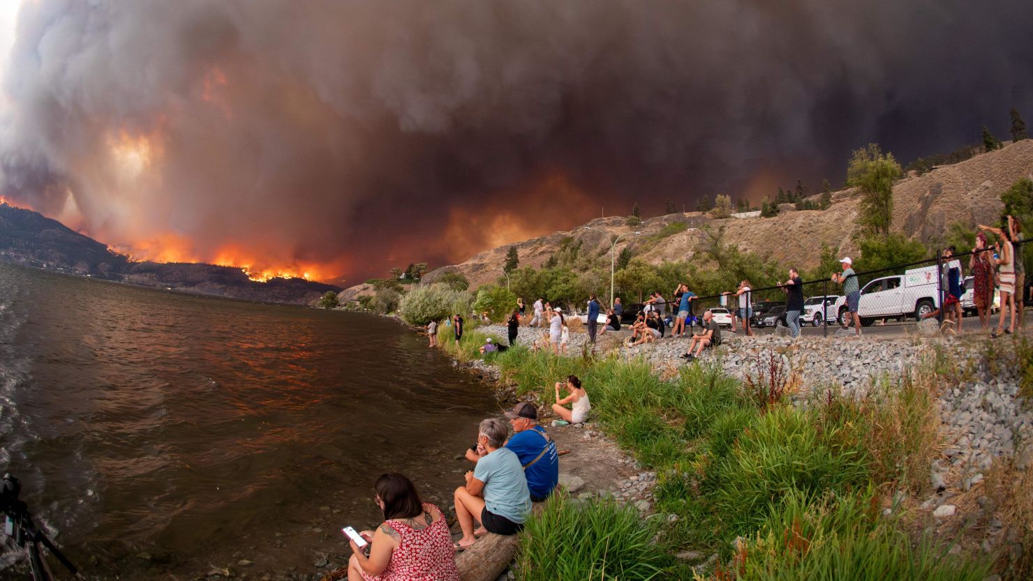 Residents watch the McDougall Creek wildfire in West Kelowna, British Columbia, Canada, on August 17, 2023, from Kelowna.