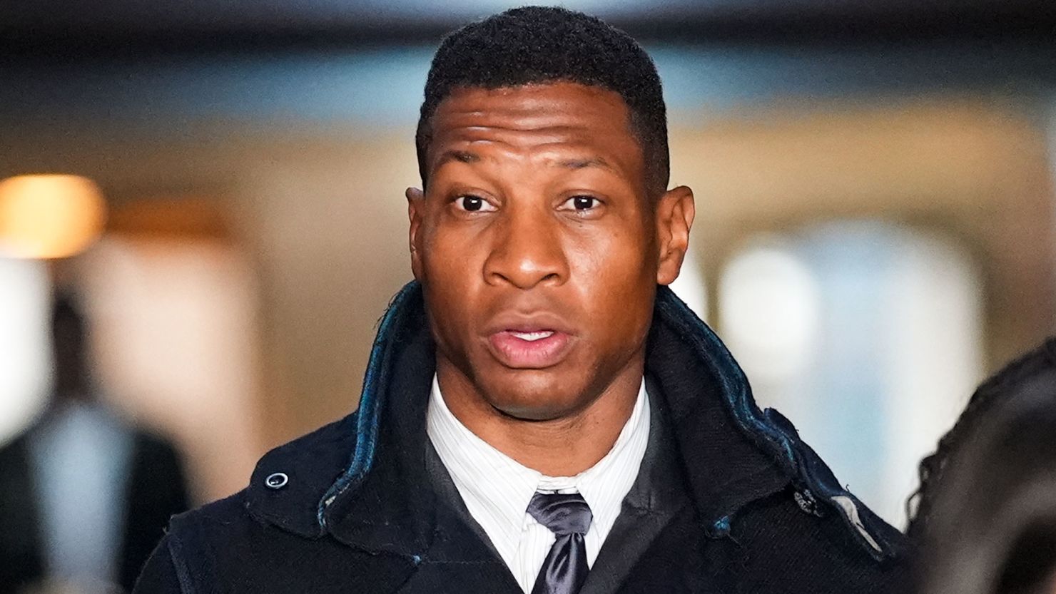 NEW YORK, NEW YORK - DECEMBER 15: Actor Jonathan Majors leaves the courthouse following closing arguments in Majors' domestic violence trial at Manhattan Criminal Court on December 15, 2023 in New York City. Majors had plead not guilty but faces up to a year in jail if convicted on misdemeanor charges of assault and harassment of an ex-girlfriend. (Photo by John Nacion/Getty Images)