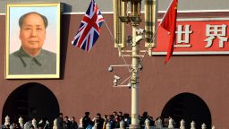 A British and a Chinese flag are displayed near the portrait of late Chinese leader Mao Zedong at Tiananmen Square in Beijing December 2, 2013.