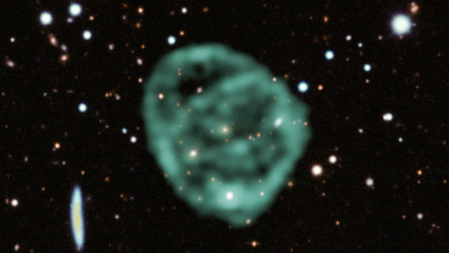 Data from SARAO's MeerKAT radio telescope data (green) showing the odd radio circles, is overlaid on optical and near infra-red data from the Dark Energy Survey.