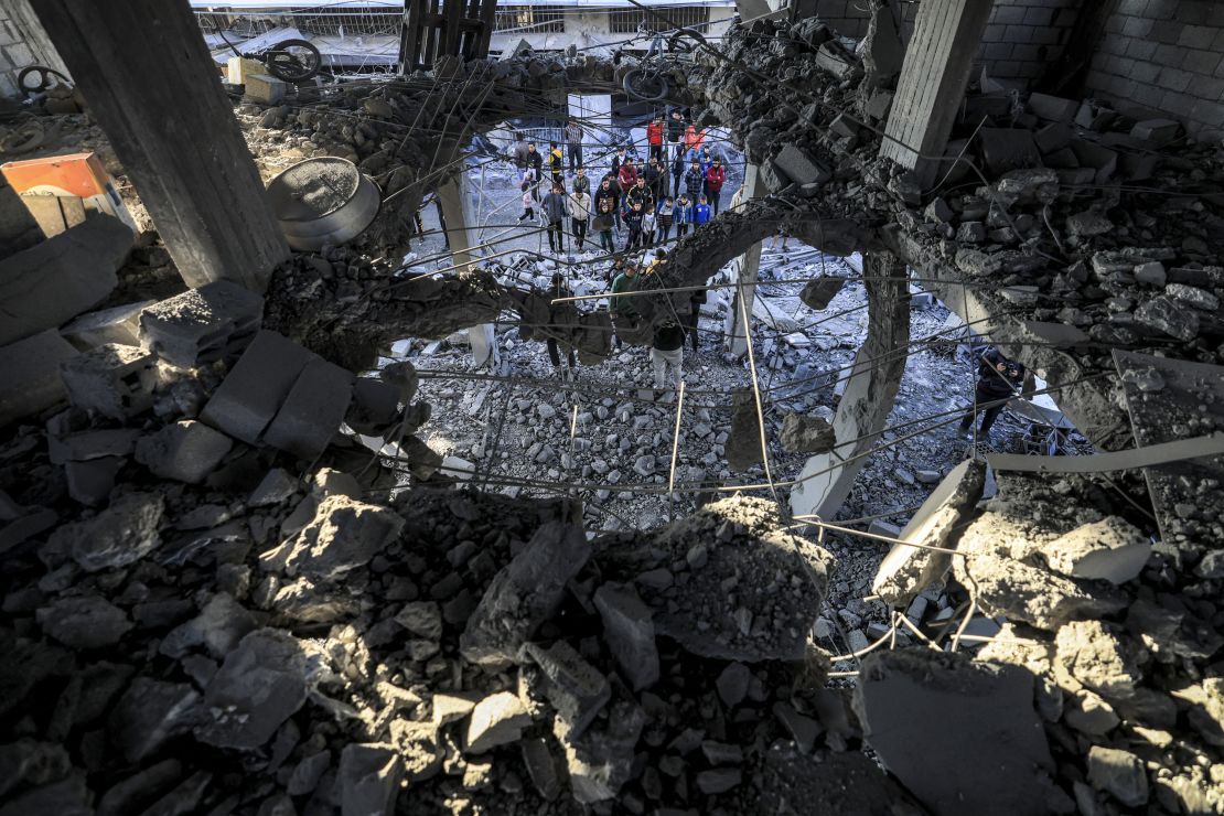 TOPSHOT - People inspect the rubble of a building where the displaced Palestinian Jabalieh family were sheltering after it was hit by Israeli bombardment in Rafah in the southern Gaza Strip on January 3, 2024 amid the ongoing conflict between Israel and the Palestinian militant group Hamas. (Photo by AFP) (Photo by -/AFP via Getty Images)