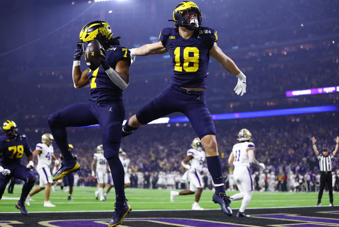 HOUSTON, TEXAS - JANUARY 08: Donovan Edwards #7 of the Michigan Wolverines celebrates with Colston Loveland #18 after running the ball for a touchdown in the first quarter against the Washington Huskies during the 2024 CFP National Championship game at NRG Stadium on January 08, 2024 in Houston, Texas. (Photo by Maddie Meyer/Getty Images)