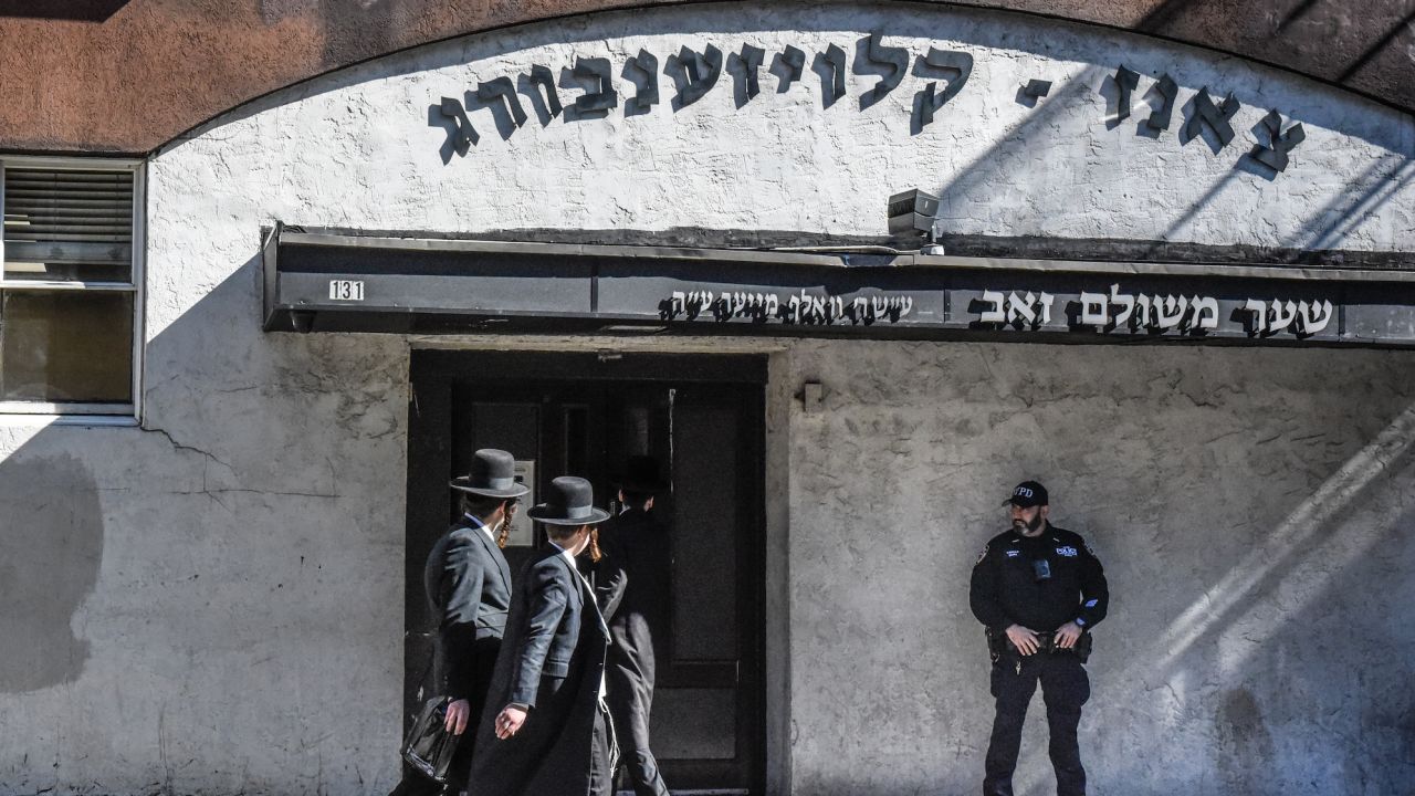 NEW YORK, NEW YORK - OCTOBER 13: A member of the New York Police Department patrols in front of a synagogue on October 13, 2023 in the Williamsburg neighborhood in the borough of Brooklyn in New York City. Security has increased in New York City in the wake of the Hamas attack on Israel and after a former leader of Hamas called for Friday the 13th to be a global Jihad day. (Photo by Stephanie Keith/Getty Images)