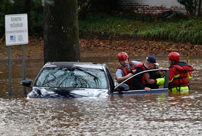 Firefighters rescue a man after his car was stuck in a flooded area in Charlotte, North Carolina, on January 9.