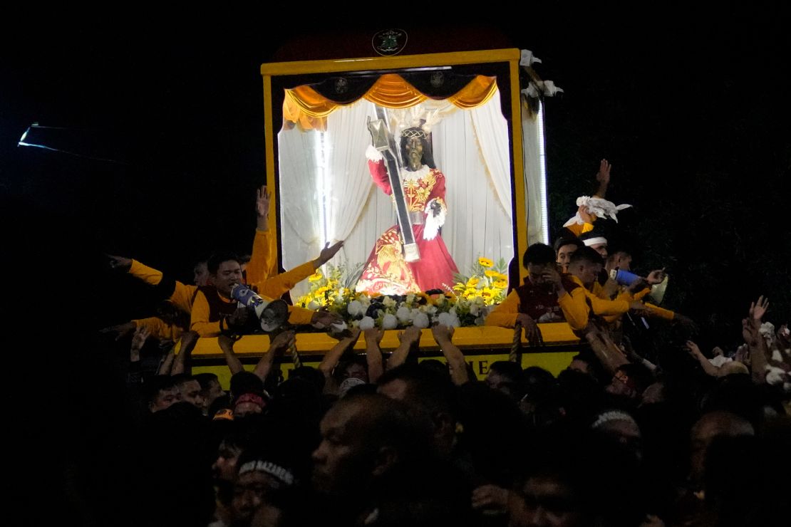 Devotees pull the statue of the Black Nazarene during its annual procession which was resumed after a three-year suspension due to the coronavirus pandemic on Tuesday, Jan. 9, 2024 in Manila, Philippines. A mammoth crowd of mostly barefoot Catholic devotees joined a chaotic procession through downtown Manila Tuesday to venerate a centuries-old black statue of Jesus Christ with many praying for peace in the Middle East where Filipino relatives work. (AP Photo/Aaron Favila)