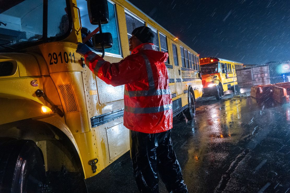 NEW YORK, NEW YORK - JANUARY 09: Nearly 2,000 migrants are evacuated by school buses from tents at Floyd Bennett Field to a local high school in preparation for a storm with estimated wind speeds to be more than 70 mph. on January 09, 2024 in the Brooklyn borough of New York City. Amid the arrival of winter weather, many migrant families are being forced to re-apply for shelter after reaching the 60-day limit for city housing. More than 4,000 families have been served notice on a rolling basis that they will need to re-apply without guarantee of receiving a place. More than 100,000 migrants have arrived in New York City over the last year.  (Photo by Spencer Platt/Getty Images)