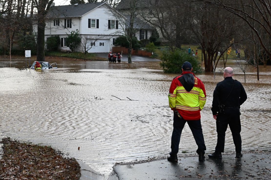 CHARLOTTE, USA - JANUARY 9: Firefighters rescue a man in car stuck in the flooded area as strong storms move through the southeast and the Carolinas producing flooding, powerful winds and tornadoes in Charlotte, NC, United States on January 09, 2024. (Photo by Peter Zay/Anadolu via Getty Images)