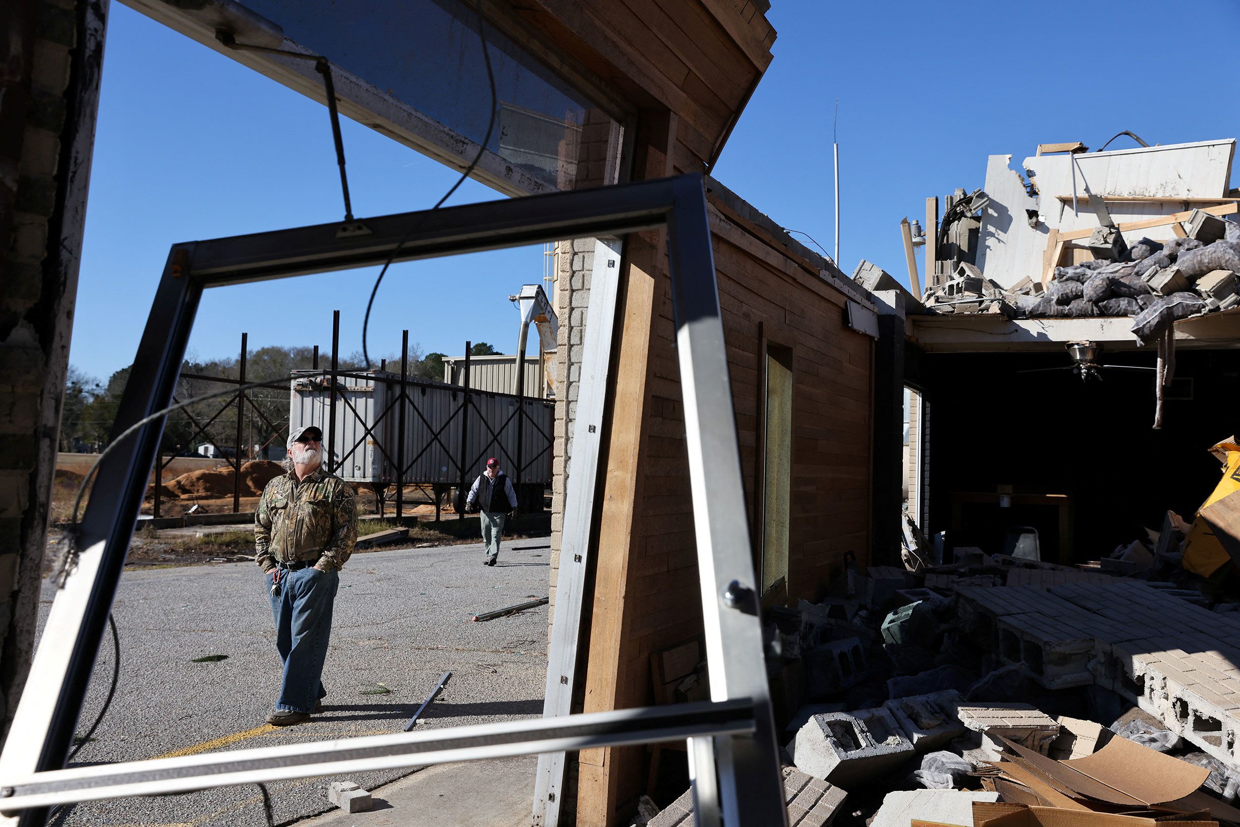 A man looks over a heavily damaged oak-barrel factory in Bamberg, South Carolina, on Wednesday, a day after a tornado struck the city.