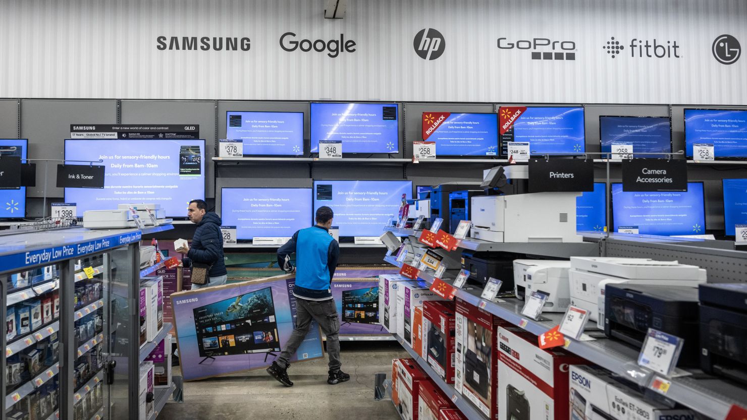 A worker stocks televisions at a Walmart store on Black Friday in Secaucus, New Jersey, US, on Friday, Nov. 24, 2023. An estimated 182 million people are planning to shop from Thanksgiving Day through Cyber Monday, the most since 2017, according to the National Retail Federation. Photographer: Victor J. Blue/Bloomberg via Getty Images